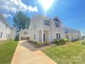Beautiful two-story home with a detached garage and long driveway on a bright, sunny day at 4017 Grommet Ct, Matthews, NC 28105