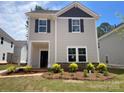 Charming two-story house featuring stone accents, dark shutters, and a landscaped front yard at 4017 Grommet Ct, Matthews, NC 28105