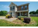Attractive two-story home with a brick and siding exterior, featuring a well-maintained front garden at 4301 Windjammer Sw Ct, Concord, NC 28027