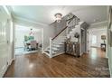 Elegant foyer featuring hardwood floors, staircase, and dining room view at 5135 Winding Brook Rd, Charlotte, NC 28226