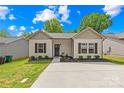 Charming single-story home with a well-manicured lawn and a paved driveway at 5648 Woodard St, Charlotte, NC 28269