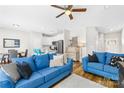 Bright living room featuring stylish blue couches and an open floor plan connected to the kitchen at 5648 Woodard St, Charlotte, NC 28269
