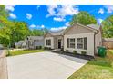 A row of attractive single-story homes, each with a well-maintained yard and a modern design at 5648 Woodard St, Charlotte, NC 28269