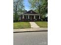 Traditional brick home with a welcoming front porch and well-maintained lawn at 621 Benton St, Monroe, NC 28110