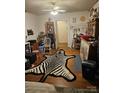 Eclectic living room featuring hardwood floors and unique decor, including a zebra-striped rug at 621 Benton St, Monroe, NC 28110