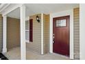 Charming covered porch showcasing a stylish front door with glass accents at 6430 Matlea Ct, Charlotte, NC 28215