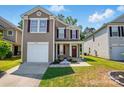 Charming home with neutral siding, red shutters, manicured lawn, and single car garage at 6430 Matlea Ct, Charlotte, NC 28215