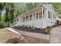 Beautiful exterior view of a home with a long front porch and manicured landscaping at 6719 Woodshed Cir, Charlotte, NC 28270