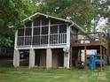 Exterior view showcasing the screened-in porch and upper deck, ideal for relaxation at 6813 Navajo Trl, Sherrills Ford, NC 28673