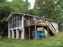 Side exterior showing deck with table and chairs, plus screened in porch at 6813 Navajo Trl, Sherrills Ford, NC 28673