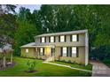 Beautiful two-story home with mature trees, a manicured lawn, and classic black shutters creating a welcoming ambiance at 7016 Wannamaker Ln, Charlotte, NC 28226