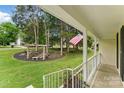 Inviting front porch with white railings and a charming garden featuring a rustic arbor and seating area at 7016 Wannamaker Ln, Charlotte, NC 28226