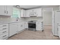 Modern kitchen with white cabinets, stainless steel appliances and ample counter space at 7016 Wannamaker Ln, Charlotte, NC 28226