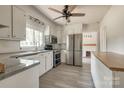 Bright kitchen features stainless steel appliances, white cabinets and grey countertops at 85 Sw Myrtle Sw Ave, Concord, NC 28025
