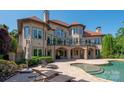 Luxury home featuring an outdoor pool and patio area perfect for entertaining and relaxation at 8904 Woodhall Lake Dr, Waxhaw, NC 28173