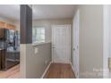 Inviting entryway with wood-look flooring, neutral paint, and a view into the kitchen area at 118 Barnhardt Loop, Mooresville, NC 28117