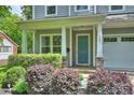 Inviting front door with stone accents, surrounded by lush landscaping, adding curb appeal at 1209 Leigh Ave, Charlotte, NC 28205