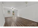 Bright sunroom with wood-look flooring, and a glass door to the backyard at 13660 Meade Glen Ct, Charlotte, NC 28273