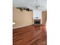 Spacious living room featuring hardwood floors, a fireplace, and plenty of natural light at 14343 Arbor Ridge Dr, Charlotte, NC 28273