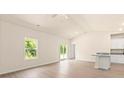 Open living space with a window view, light walls and floors, and access to the kitchen and sliding glass door at 1528 Doran Ter, Richburg, SC 29729