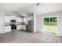 Open-concept kitchen with stainless steel appliances and dining area featuring sliding door to backyard at 1554 Doran Ter, Richburg, SC 29729