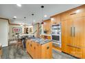 Modern kitchen featuring custom cabinetry, granite countertops, stainless steel appliances, and a breakfast bar at 16317 Terry Ln, Huntersville, NC 28078