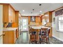 Modern kitchen featuring custom cabinetry, granite countertops, stainless steel appliances, and a breakfast bar at 16317 Terry Ln, Huntersville, NC 28078