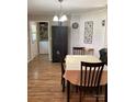 Cozy dining area with wooden table and chairs, adjacent to the laundry and a brick accent wall at 1750 Sells Rd, Salisbury, NC 28144