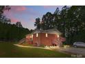 Inviting brick home featuring a dual elevated deck design and a mature tree lined perimeter at 1792 Hoffman Rd, Gastonia, NC 28054
