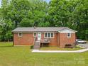 Charming brick home featuring a metal roof, cozy front porch, and well-maintained lawn at 1792 Hoffman Rd, Gastonia, NC 28054