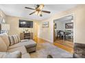 Stylish living area boasting hardwood floors, a comfortable couch, and an open flow into the dining area at 1792 Hoffman Rd, Gastonia, NC 28054