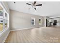 Spacious living room featuring light wood floors, neutral walls, a ceiling fan, and natural light at 213 Benfield Rd, Kings Mountain, NC 28086