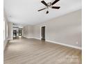 Open-concept living room offers natural light, neutral walls, and sleek flooring leading to the kitchen at 213 Benfield Rd, Kings Mountain, NC 28086