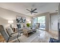 Cozy living room featuring a ceiling fan, fireplace, and sliding glass door to the patio at 2209 Sumner Green Ave # M, Charlotte, NC 28203