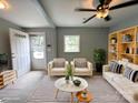 Bright, staged living room with modern decor, a striped rug, and comfortable seating arrangement at 2328 Milton Ave, Gastonia, NC 28052