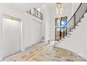 Bright entryway featuring a stunning chandelier and staircase at 242 Shoreline Loop, Mooresville, NC 28117