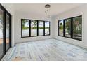 Spacious room with lots of light, neutral walls, black trim windows, and lake views at 242 Shoreline Loop, Mooresville, NC 28117