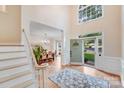 Welcoming foyer with hardwood floors, high ceilings, and views of the dining area and front yard at 2635 Cotton Planter Ln, Charlotte, NC 28270