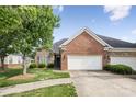 Charming home featuring a brick and stone facade, an attached two-car garage, and a well-manicured lawn at 2910 Lake James Ct, Monroe, NC 28110