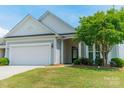 Charming home with a two-car garage, well-maintained lawn, and attractive landscaping at 3043 Santee Ct, Fort Mill, SC 29707
