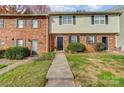 Inviting townhome featuring brick facade, black shutters, and a well-manicured front yard at 3109 Heathstead Pl, Charlotte, NC 28210