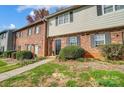 Charming townhome featuring a well-manicured lawn, brick facade, and classic black shutters at 3109 Heathstead Pl, Charlotte, NC 28210