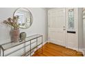 Bright foyer featuring hardwood floors, a decorative mirror, and a stylish console table at 3901 Kitley Pl, Charlotte, NC 28210
