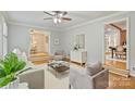 Inviting living room with hardwood floors, neutral tones, and lots of natural light at 3901 Kitley Pl, Charlotte, NC 28210