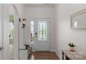 Bright entryway featuring a decorative glass door and coat rack at 4040 Deep River Way, Waxhaw, NC 28173