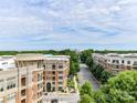 An exterior street view showcasing the urban landscape, and skyline in the distance at 4625 Piedmont Row Dr # 410, Charlotte, NC 28210