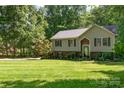 Charming two-story home with well-manicured lawn and mature trees at 4700 Hickory Grove Rd, Mount Holly, NC 28120
