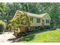Two-story home with brick accents, mature trees, and landscaped yard at 4700 Hickory Grove Rd, Mount Holly, NC 28120