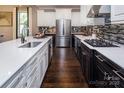 Modern kitchen featuring stainless steel appliances, dark wood floors, and white quartz countertops at 5059 Valita Rd, York, SC 29745
