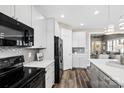 Well-lit kitchen with white cabinets, stainless appliances, and stylish backsplash at 5075 Valita Rd, York, SC 29745